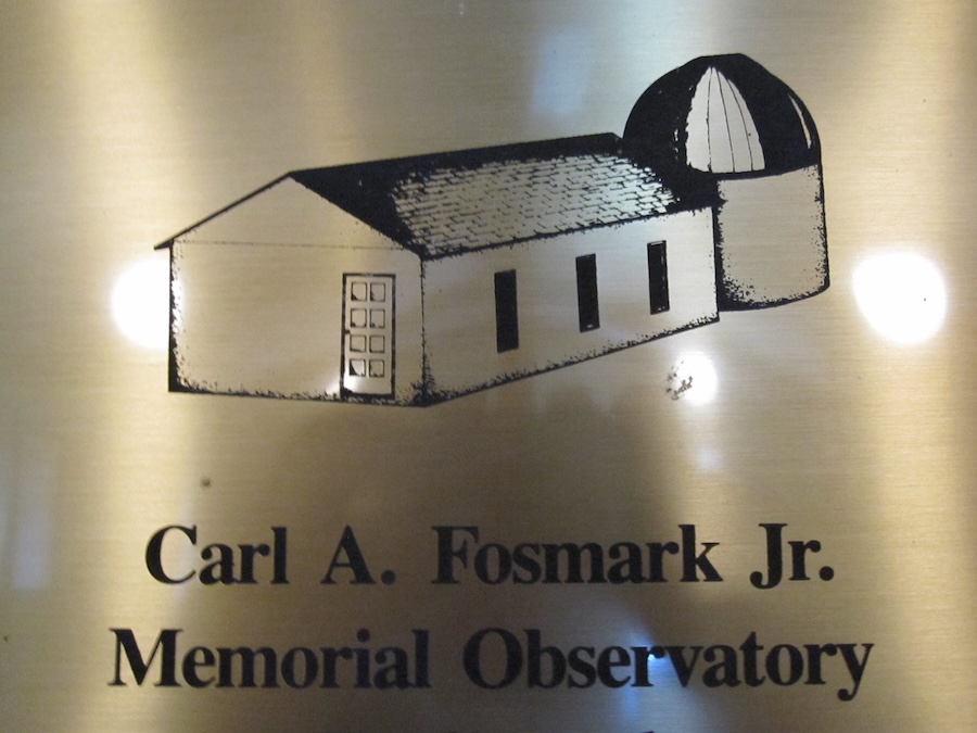 Detail from the plaque hanging on the wall at the YRS clubhouse, noting the name of the building and showing an attached observatory.